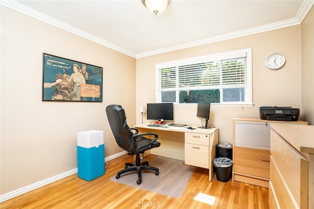 office space with light wood-style flooring, ornamental molding, and baseboards