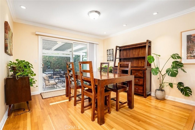 dining room with ornamental molding, recessed lighting, light wood-style flooring, and baseboards