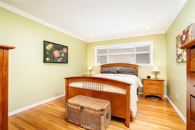 bedroom featuring ornamental molding, baseboards, and light wood finished floors