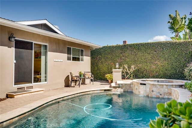 view of swimming pool featuring a patio area and a pool with connected hot tub