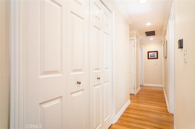 hallway with recessed lighting, visible vents, baseboards, light wood-style floors, and ornamental molding