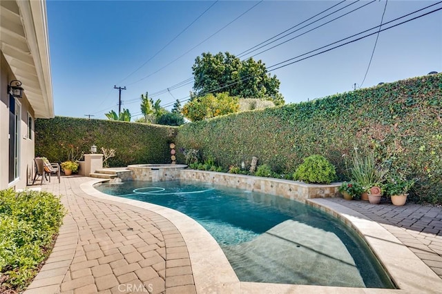 view of swimming pool with an in ground hot tub, a patio, a fenced backyard, and a fenced in pool