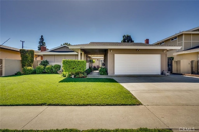 view of front facade featuring a garage, concrete driveway, a front lawn, and stucco siding