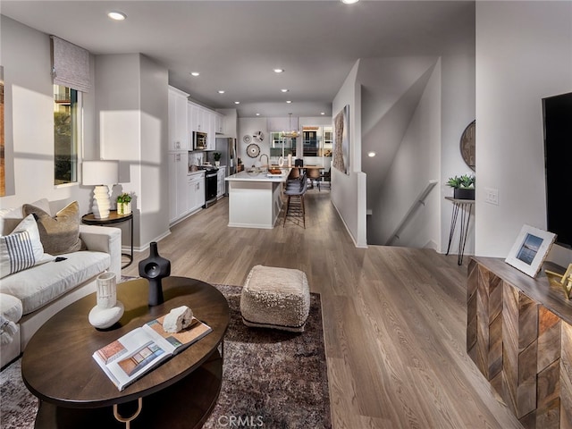 living area featuring recessed lighting and light wood-style floors