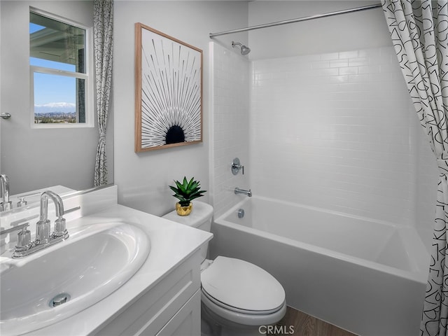 bathroom with wood finished floors, shower / bath combo, vanity, and toilet