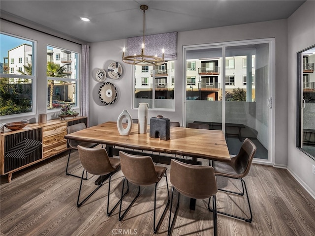 dining room featuring baseboards, an inviting chandelier, and wood finished floors