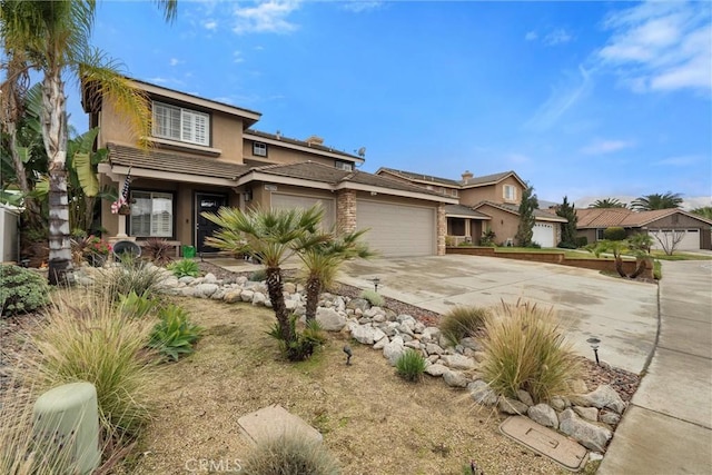 view of front facade featuring a garage, driveway, and stucco siding