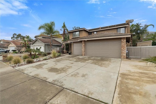 view of front facade featuring an attached garage, stone siding, concrete driveway, and stucco siding