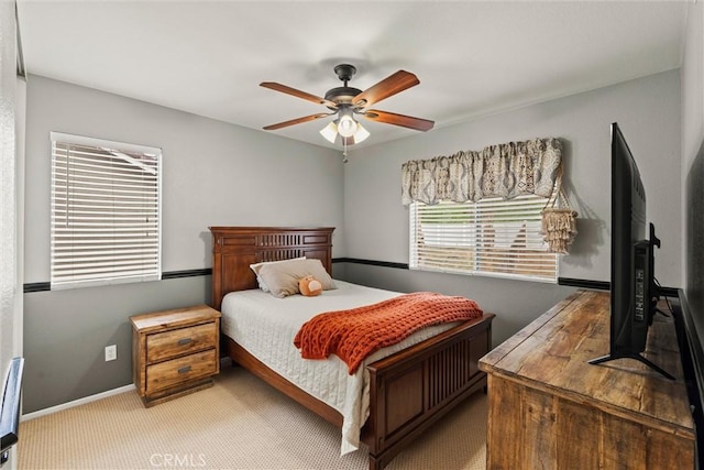 carpeted bedroom featuring a ceiling fan and baseboards