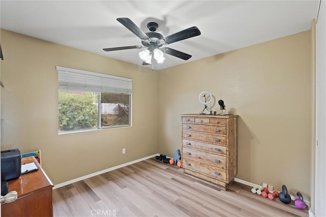 bedroom featuring baseboards, ceiling fan, and light wood-style floors