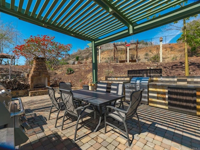 view of patio / terrace with outdoor dining area, an outdoor stone fireplace, area for grilling, exterior kitchen, and a pergola