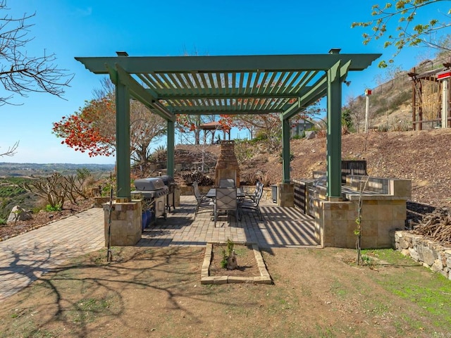 view of patio / terrace featuring area for grilling, an outdoor kitchen, and a pergola