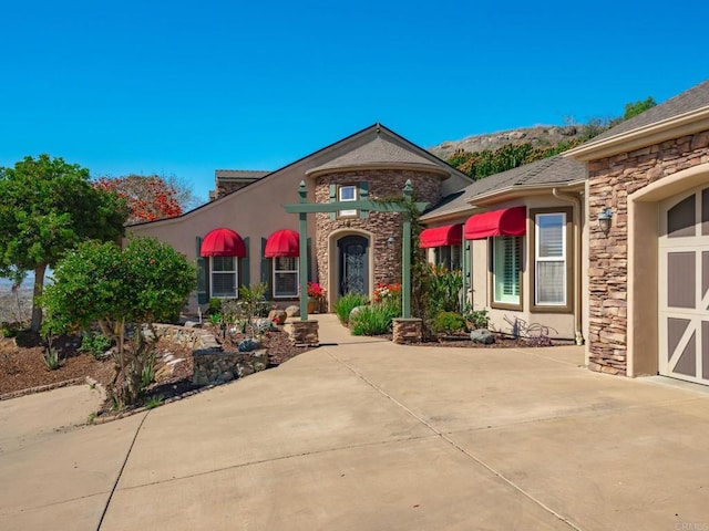 view of front of house with stone siding and stucco siding