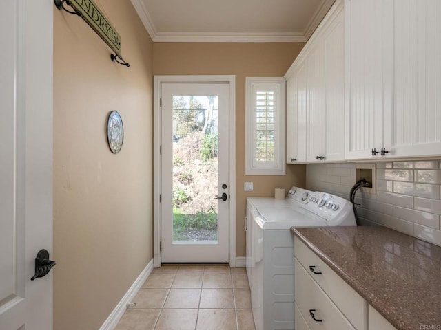 laundry area with light tile patterned floors, baseboards, ornamental molding, cabinet space, and washer and clothes dryer