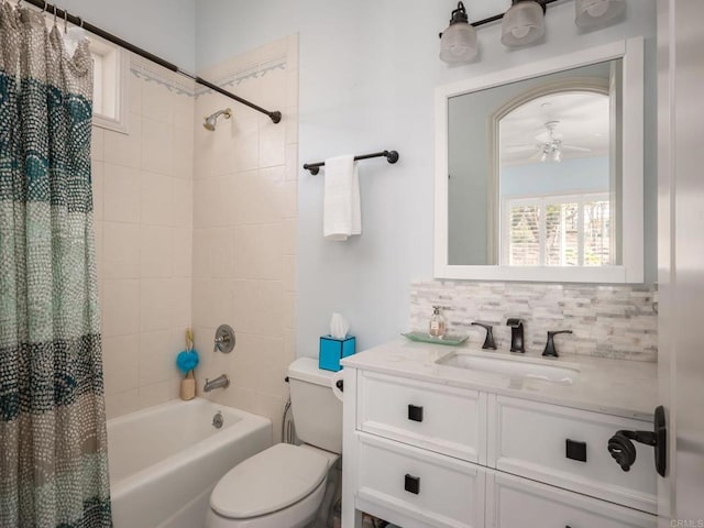 bathroom featuring tasteful backsplash, shower / bathtub combination with curtain, toilet, ceiling fan, and vanity