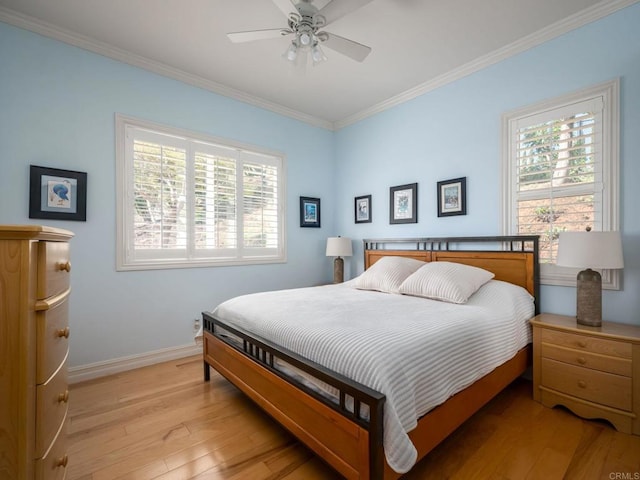 bedroom with light wood-style floors, multiple windows, ornamental molding, and baseboards