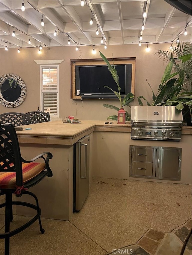 bar with refrigerator and track lighting