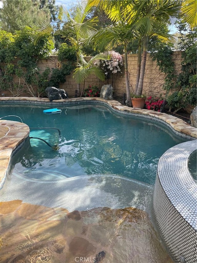 view of swimming pool featuring a fenced backyard and a fenced in pool