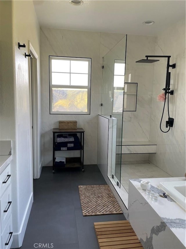 bathroom featuring a tub to relax in and walk in shower