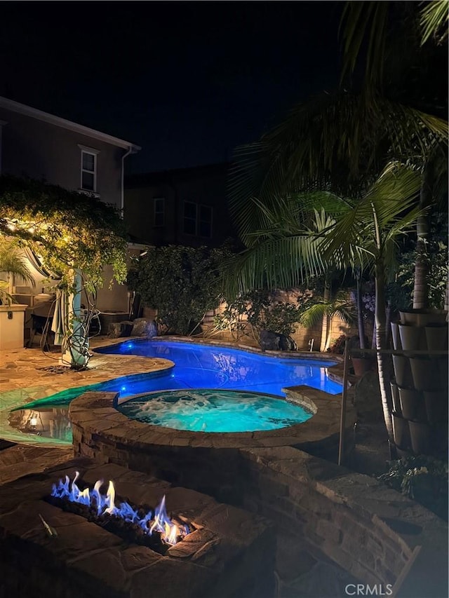 pool at twilight featuring an outdoor pool