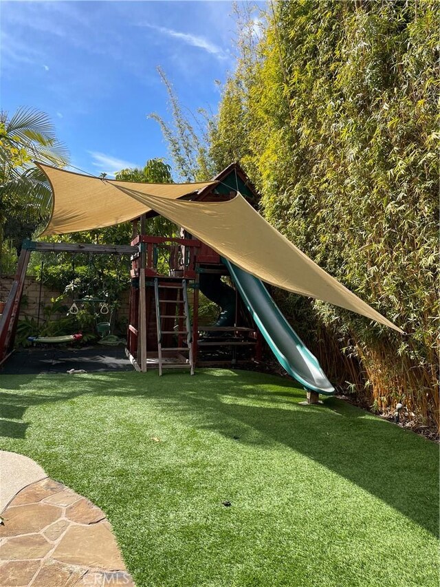 view of playground featuring a lawn