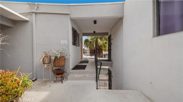 view of exterior entry with stucco siding