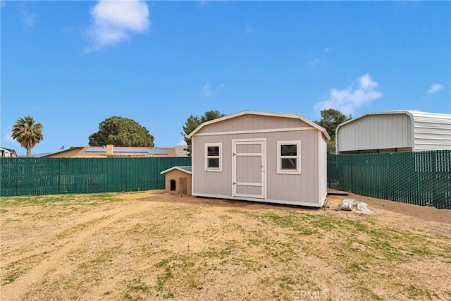 view of shed featuring a fenced backyard