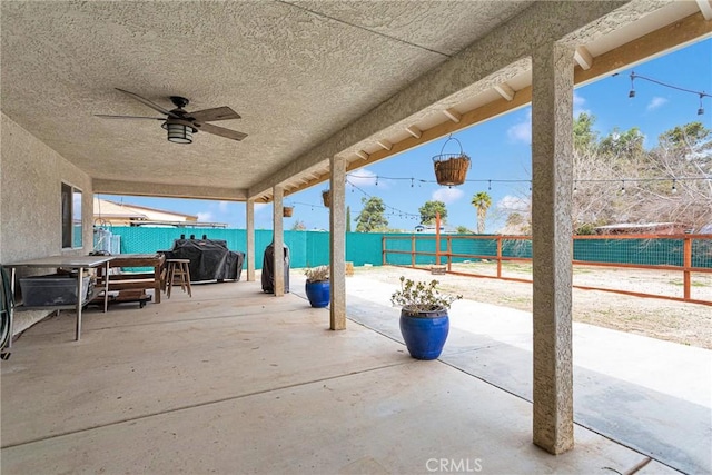 view of patio with a ceiling fan, a fenced backyard, and grilling area