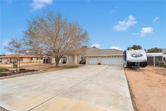 view of front of property featuring a garage and concrete driveway