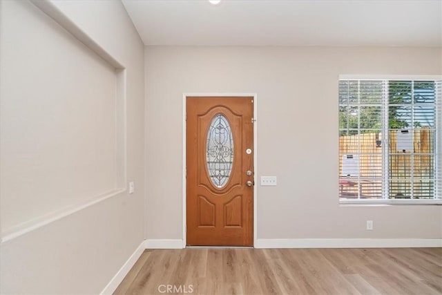 foyer entrance featuring light wood-style floors and baseboards