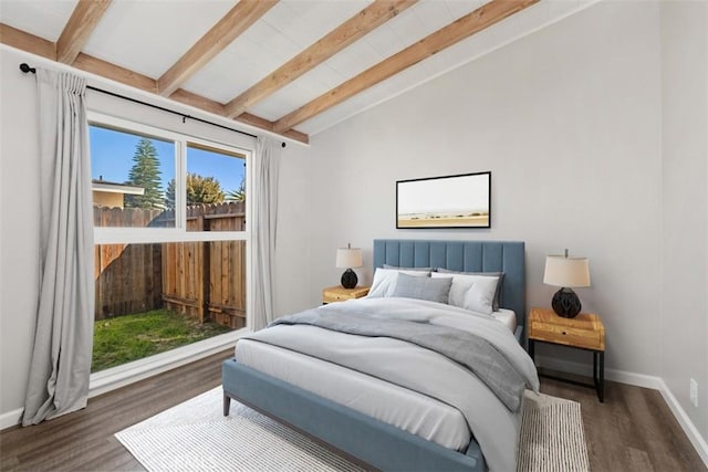 bedroom featuring vaulted ceiling with beams, baseboards, and wood finished floors