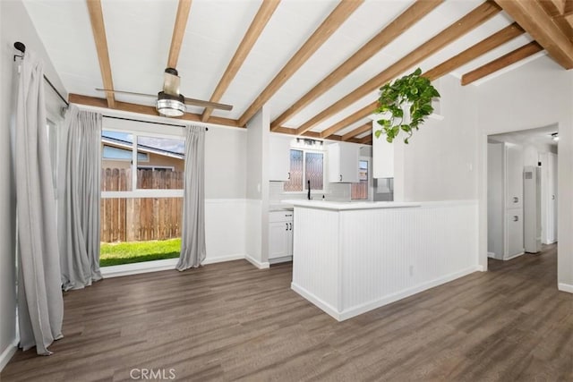 kitchen with vaulted ceiling with beams, white cabinets, wood finished floors, and light countertops