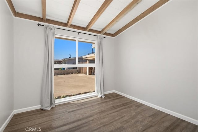 spare room with vaulted ceiling with beams, baseboards, and wood finished floors