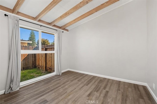 empty room with vaulted ceiling with beams, baseboards, and wood finished floors