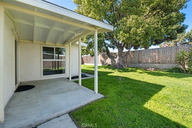 view of yard with fence and a patio