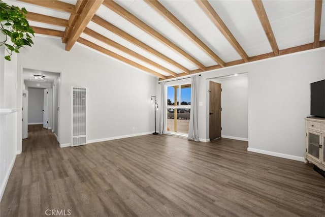 unfurnished living room featuring dark wood-type flooring, lofted ceiling with beams, and baseboards