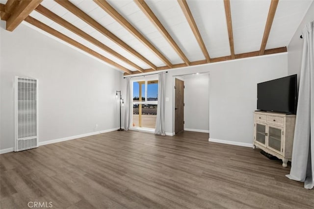 unfurnished living room featuring lofted ceiling with beams, wood finished floors, and baseboards