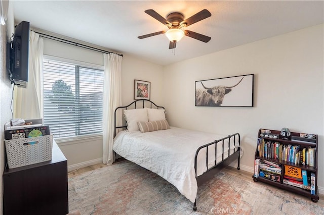 bedroom featuring ceiling fan and baseboards