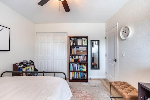 bedroom featuring a closet, a ceiling fan, and wood finished floors