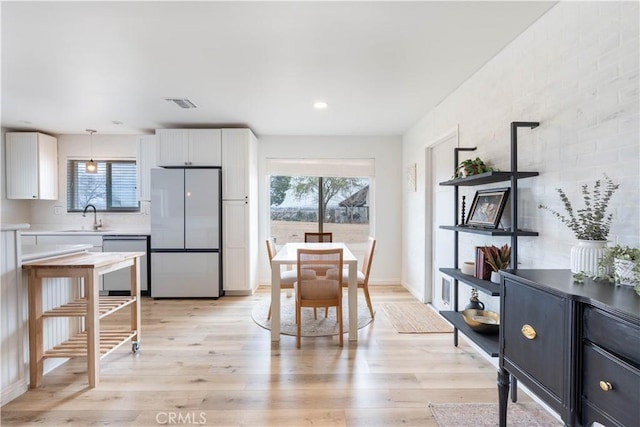 dining room featuring light wood-style flooring, visible vents, and recessed lighting