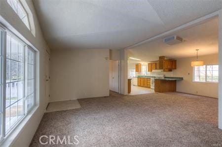 unfurnished living room featuring light colored carpet and visible vents