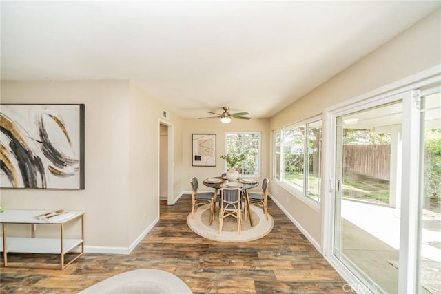 dining space with visible vents, baseboards, wood finished floors, and a ceiling fan