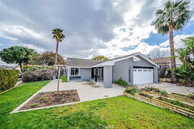 view of front of house featuring a garden, stucco siding, a front lawn, concrete driveway, and a garage