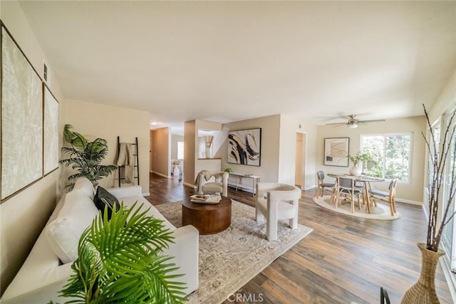 living area with wood finished floors and baseboards