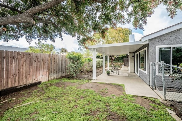 view of yard featuring a patio area and a fenced backyard