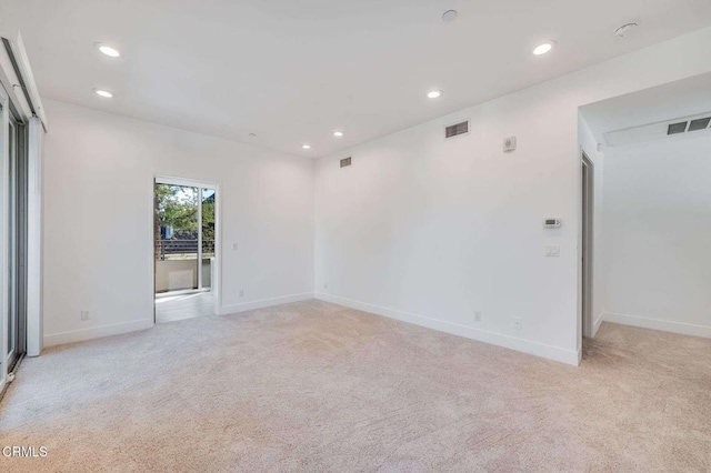 unfurnished room featuring light carpet, baseboards, visible vents, and recessed lighting