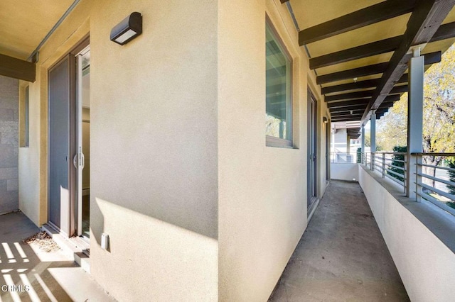 exterior space featuring a balcony and stucco siding