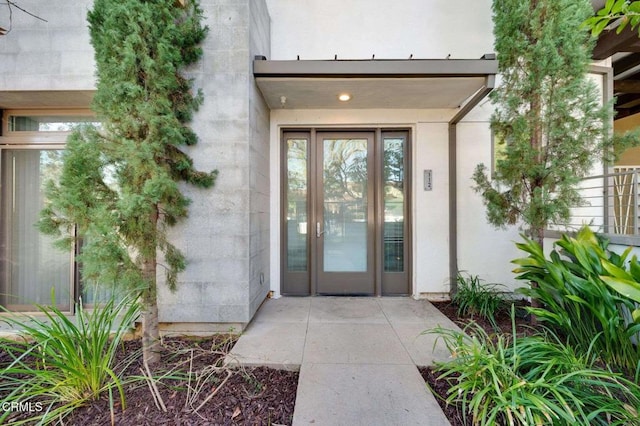 entrance to property with stucco siding