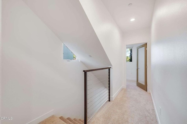hallway with carpet flooring, recessed lighting, baseboards, and an upstairs landing