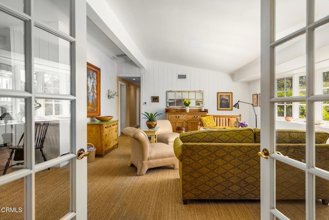 living room featuring carpet, vaulted ceiling, and french doors